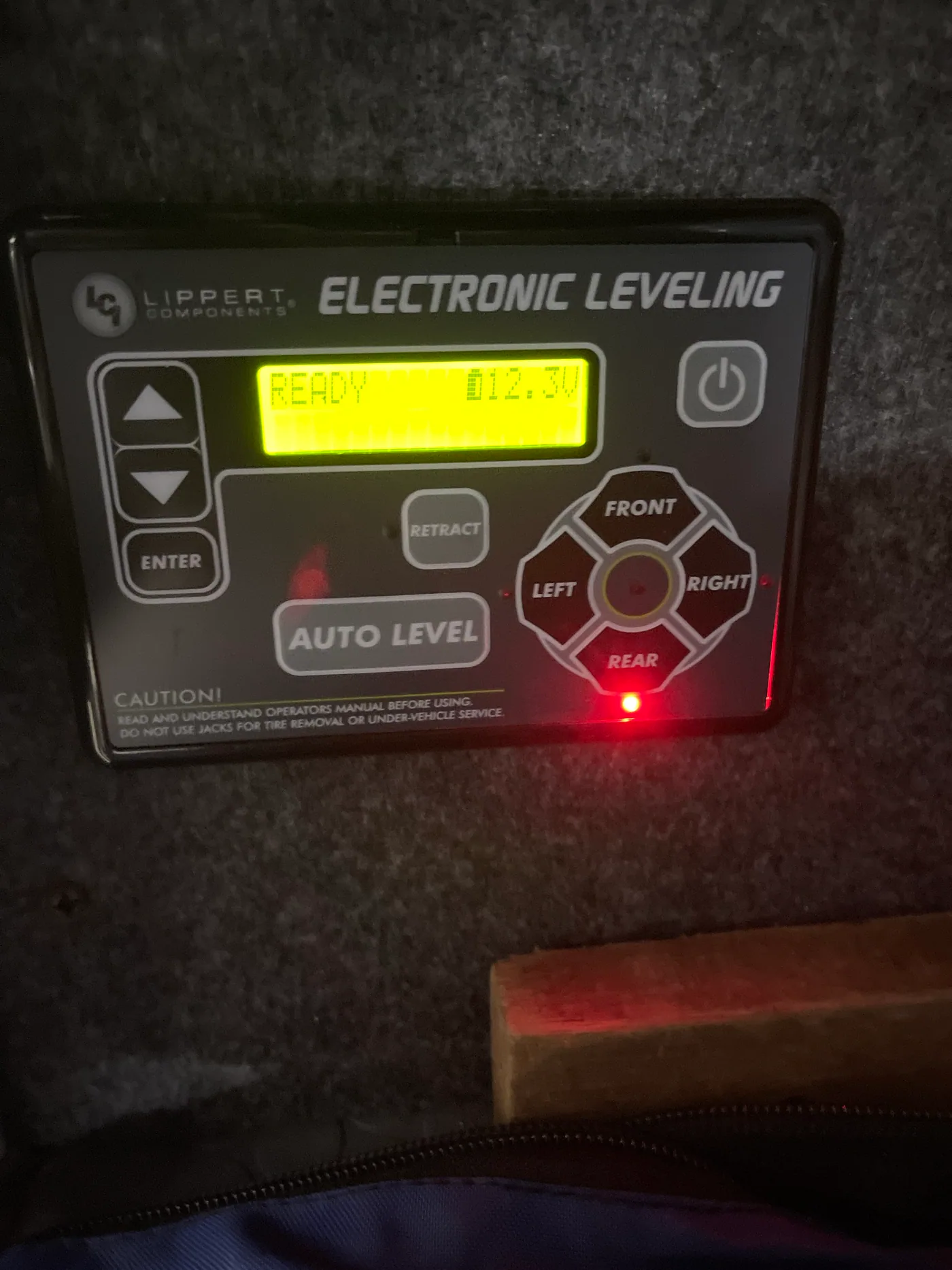Lippert electronic leveling control showing READY, 12.2 volts and a rear jack indicator