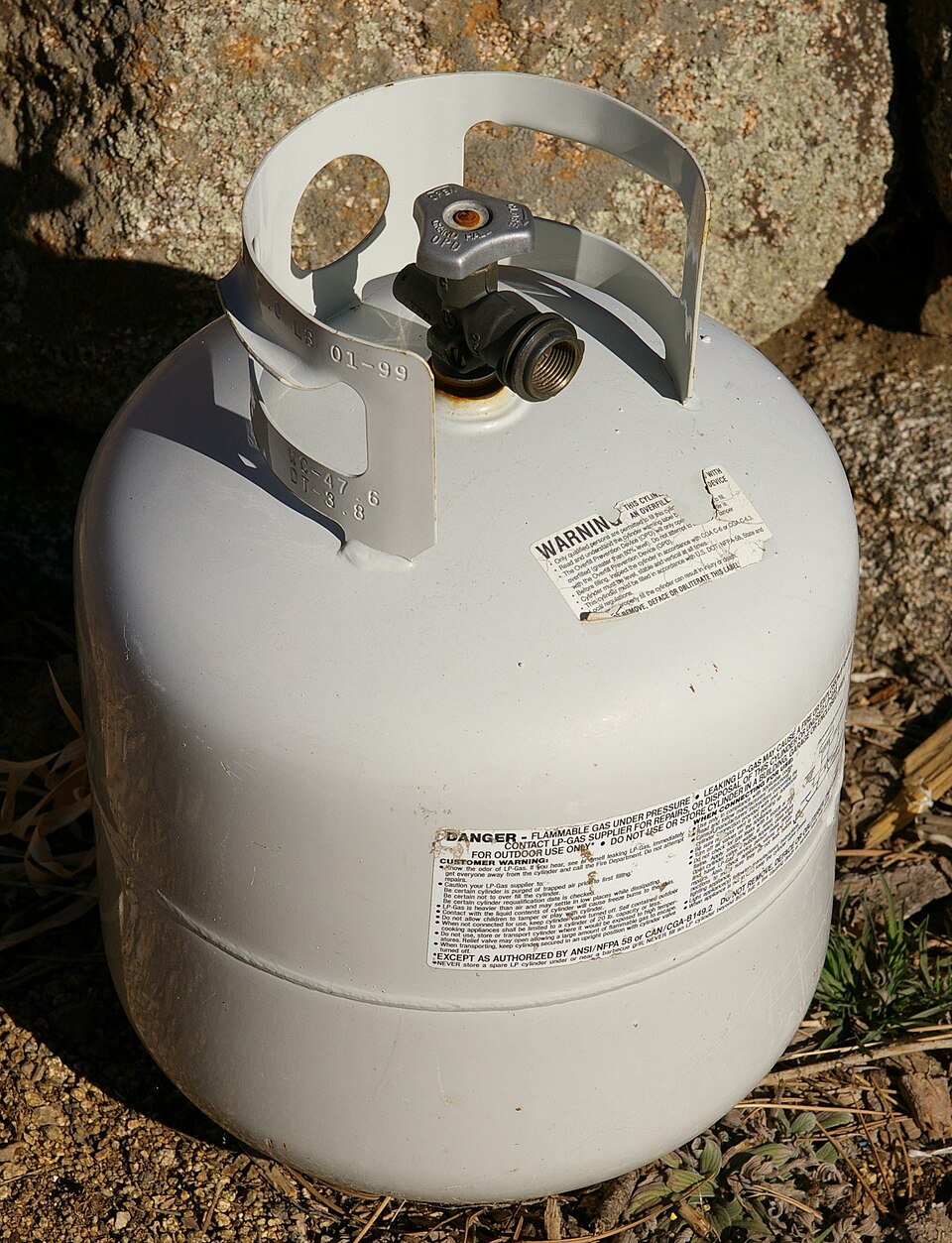 White 20-pound propane cylinder with valve and stamped collar markings