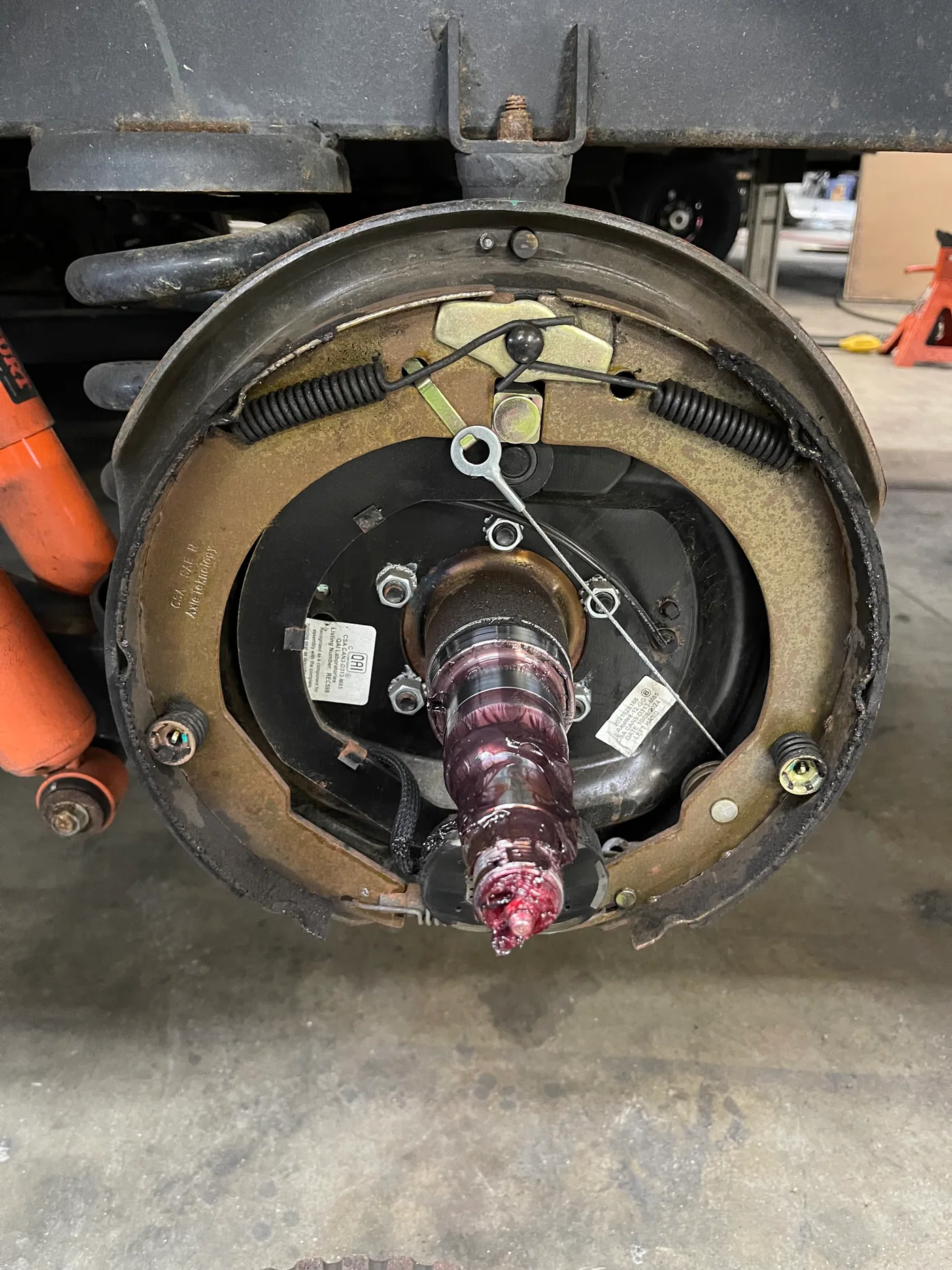 RV electric trailer drum brake assembly showing brake shoes, return springs, magnet, adjuster and spindle